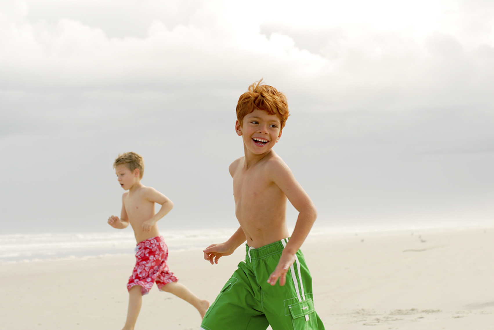 boys running on New Smyrna Beach